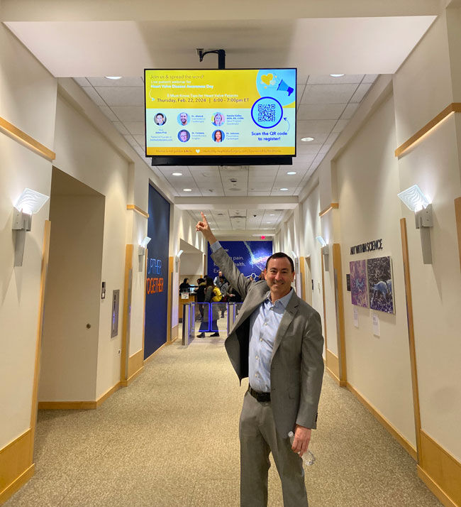 Adam Pick at Medtronic pointing at webinar invitation