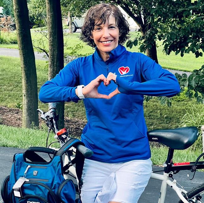 Dina wearing HVS swag outdoors with a bicycle