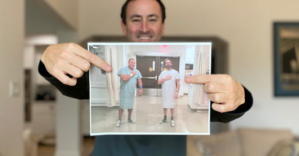 Adam Pick holding sign of patients meeting at Cleveland Clinic