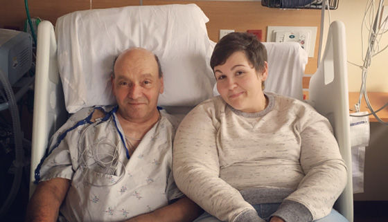 Bob Taylor, heart valve patient, with his daughter in bed