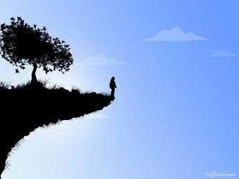 Person standing on edge of a cliff