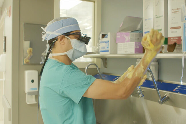 Dr. Christopher Mehta Scrubbing In for Surgery