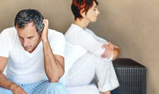 Man in bed struggling with erectile dysfunction