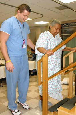 Patient Practices Going Up Stairs In Rehabilitation Class