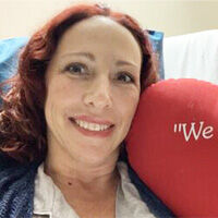 Heart Surgery Patient Smiling with Red Pillo