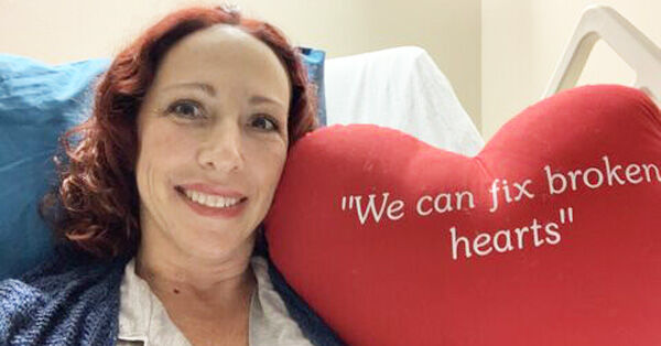 Heart Surgery Patient Smiling with Red Pillow