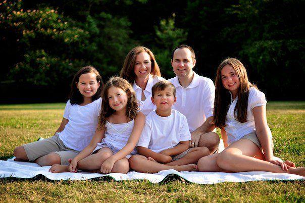 Heart valve patient with family on grass